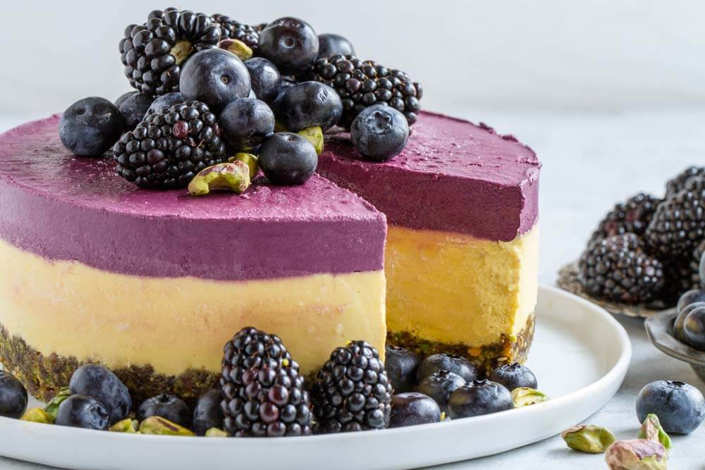 whole Mango Blackberry Cheesecake with blackberries and blueberries on top