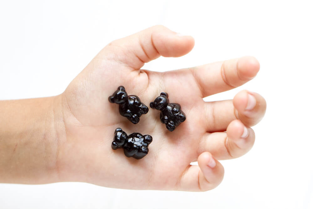 Three Elderberry Gummy Bears  in child's hand