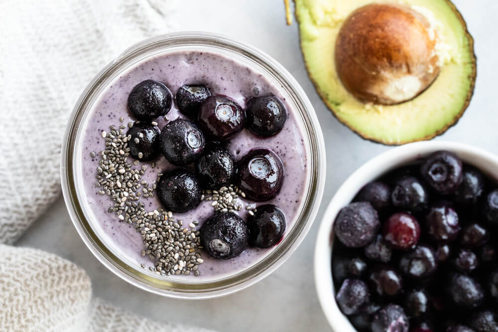 Blueberry Collagen Smoothie with avocado and blueberries on the side