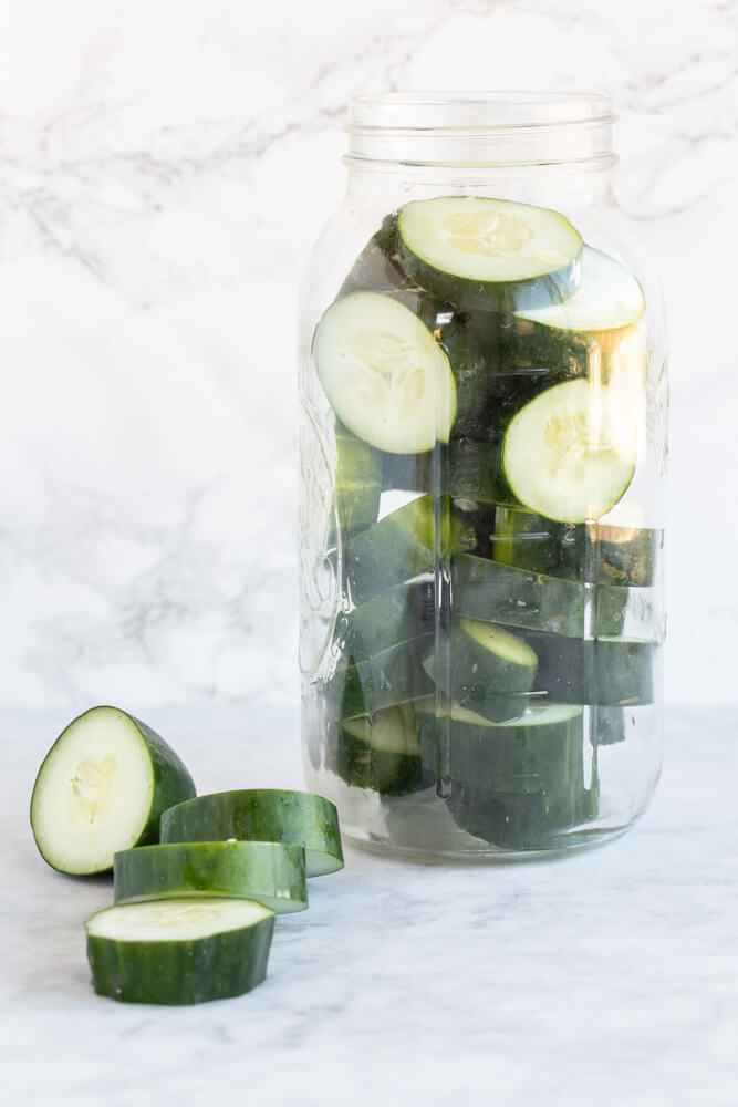 large mason jar with sliced cucumbers