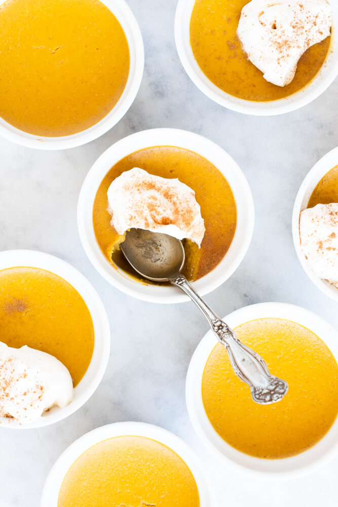 close up of white ramekin with pumpkin custard