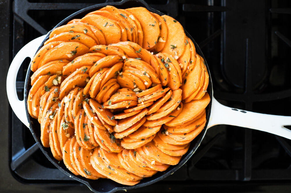 uncooked sweet potato slices in skillet
