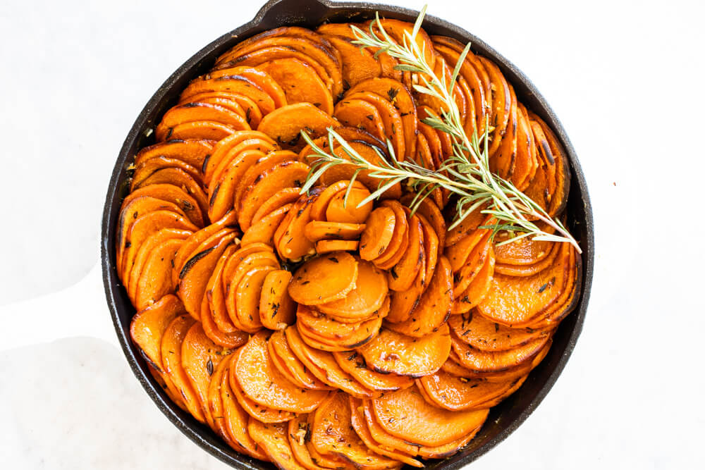 garlic and herb sweet potatoes in white skillet