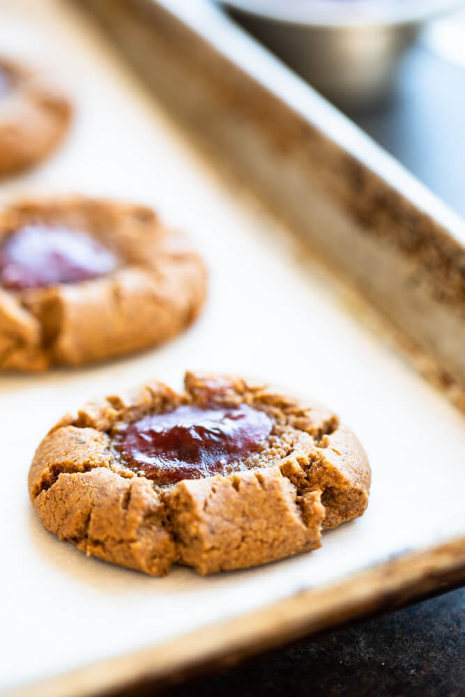 close up of peanut butter and jelly thumbprint cookie