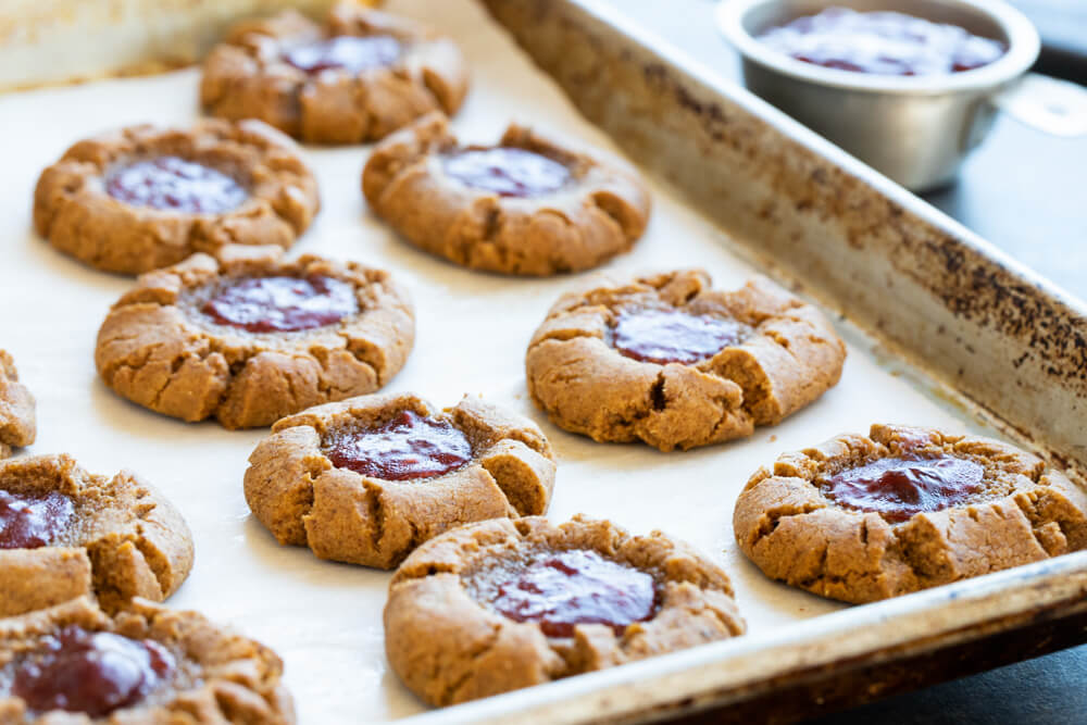 peanut butter and jelly thumbprints on cookie sheet