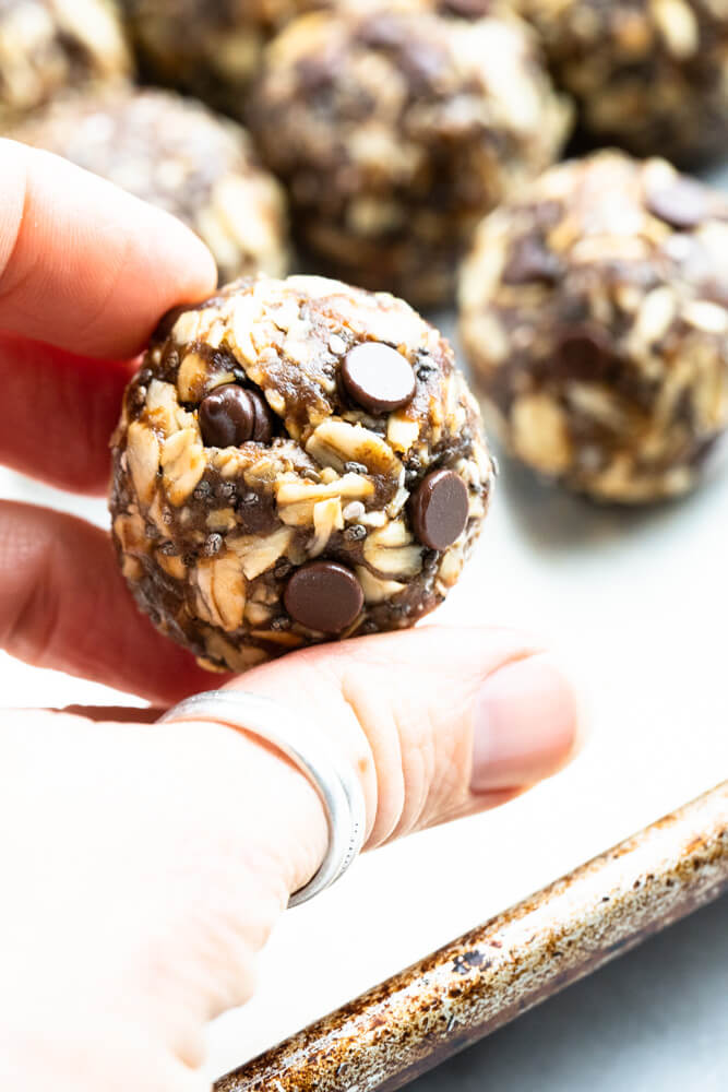 close up of hand holding a gingerbread energy ball