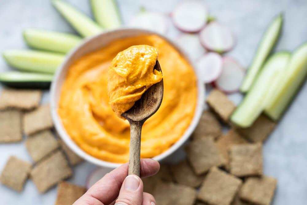 wooden spoon with sweet potato hummus on it