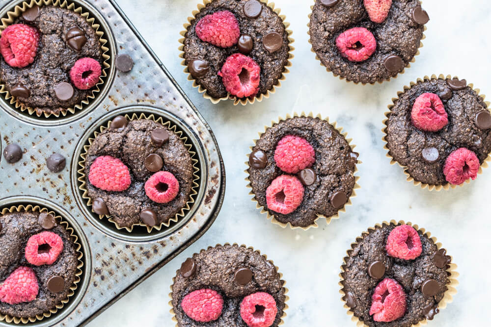 chocolate raspberry muffins on a white counter