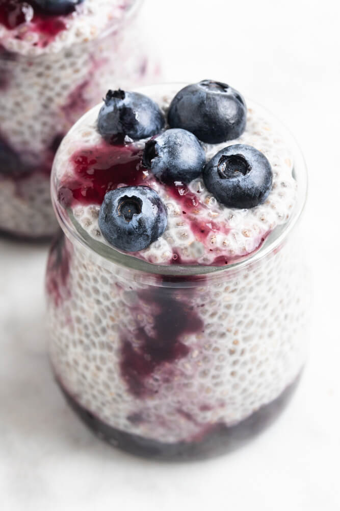 close up of glass jar of blueberry chia pudding