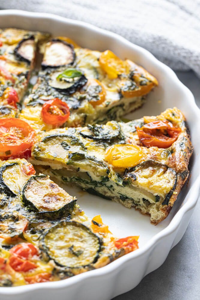 close up of a slice of vegetable quiche