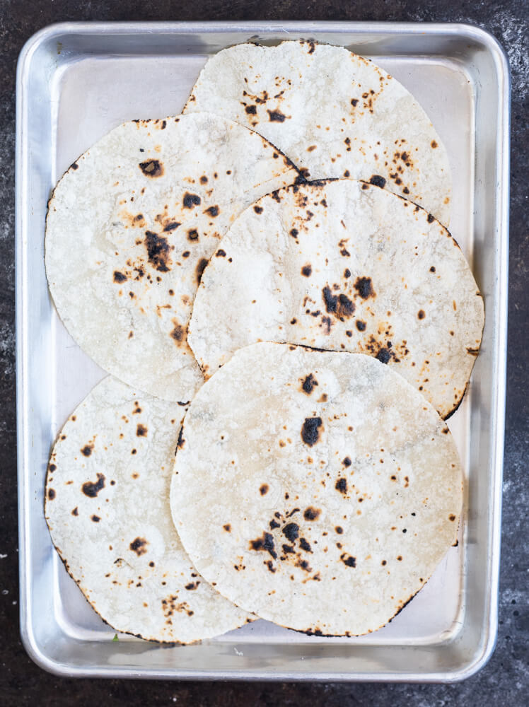 charred tortillas on a sheet pan