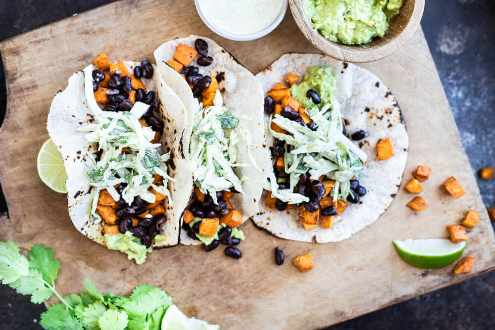 three black bean tacos on cutting board