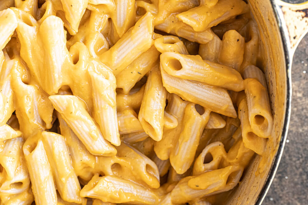 close up of butternut squash pasta in yellow pot