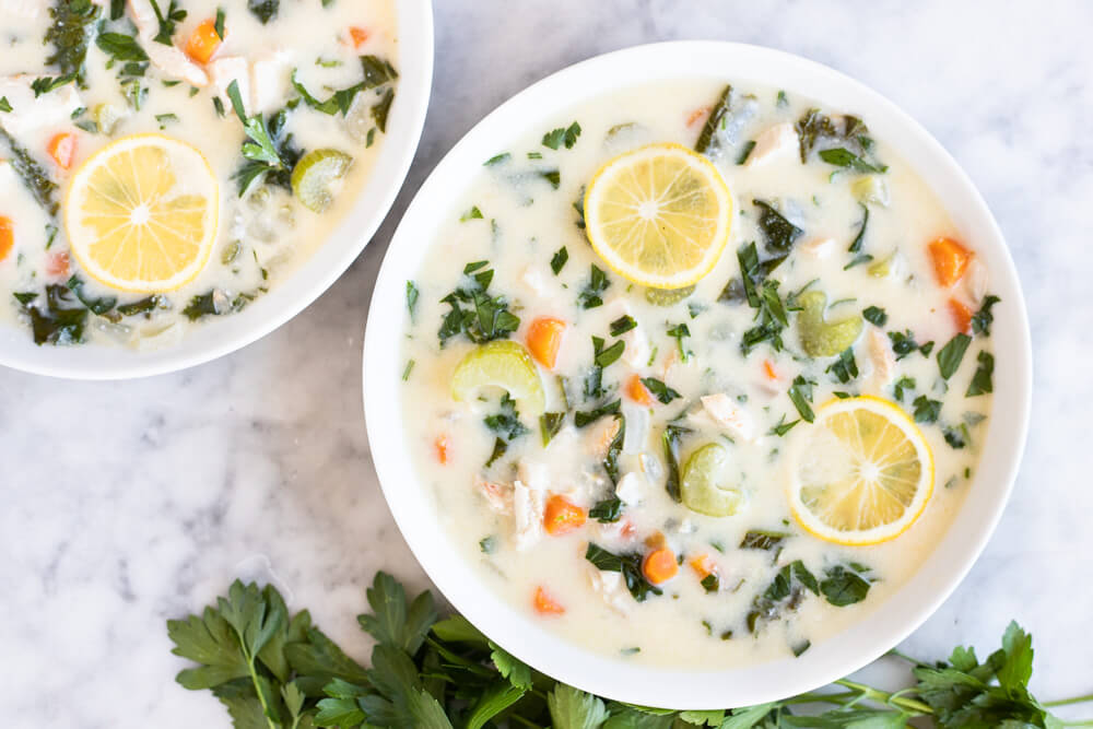 two white bowls of chicken soup