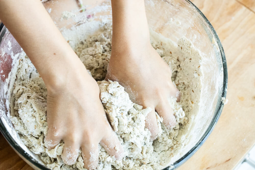 hands mixing bread dough