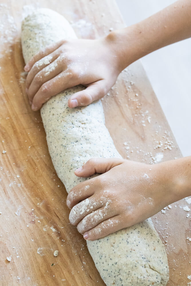 hands rolling bread dough