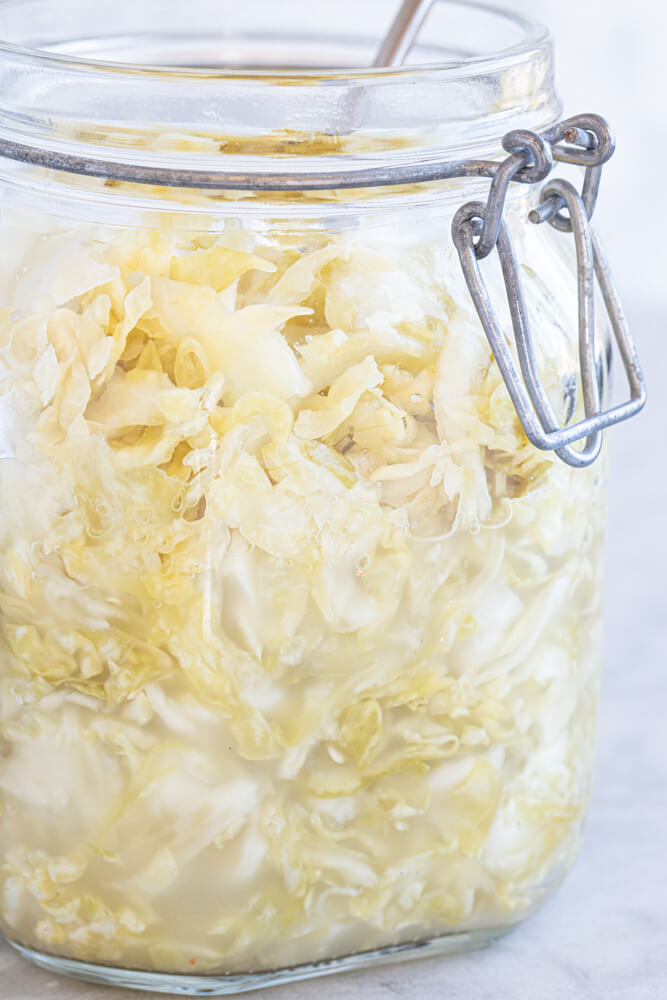 glass jar full of sauerkraut