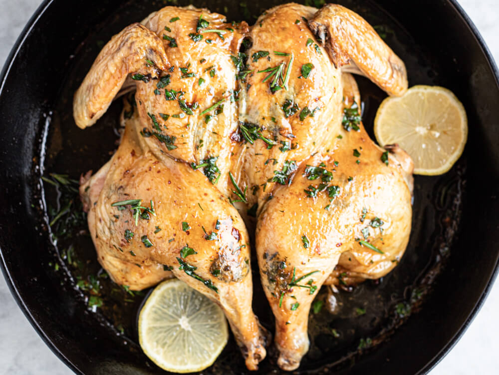 whole roasted chicken in black skillet