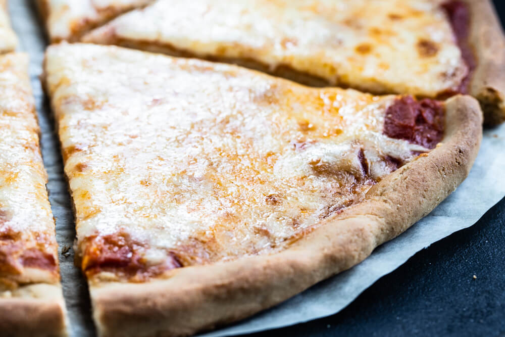 close up of pizza on black pan