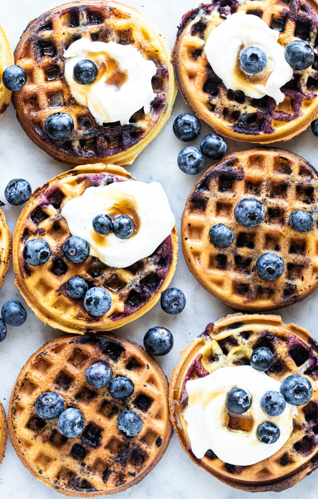 six mini waffles with blueberries and cream