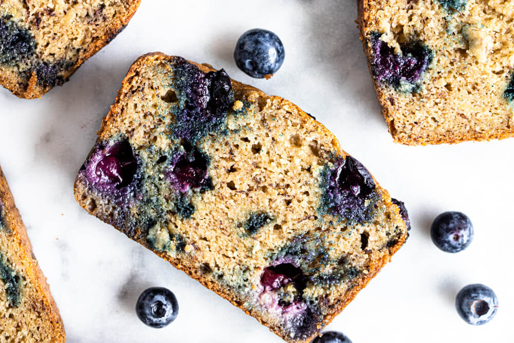 close up of slice of banana bread with blueberries