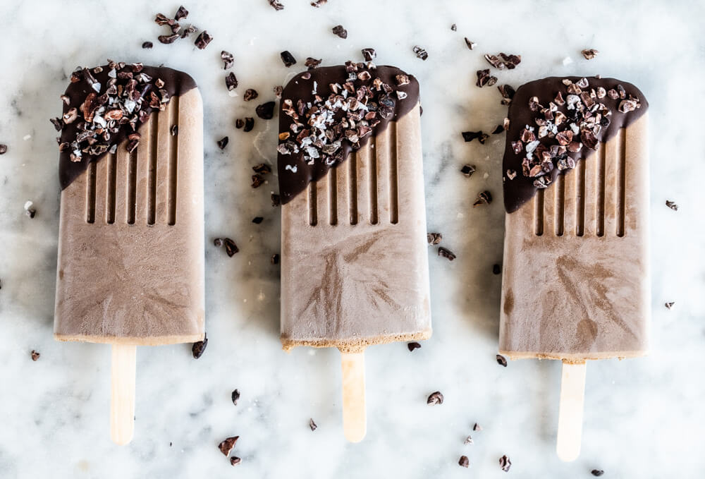 three popsicles on white counter