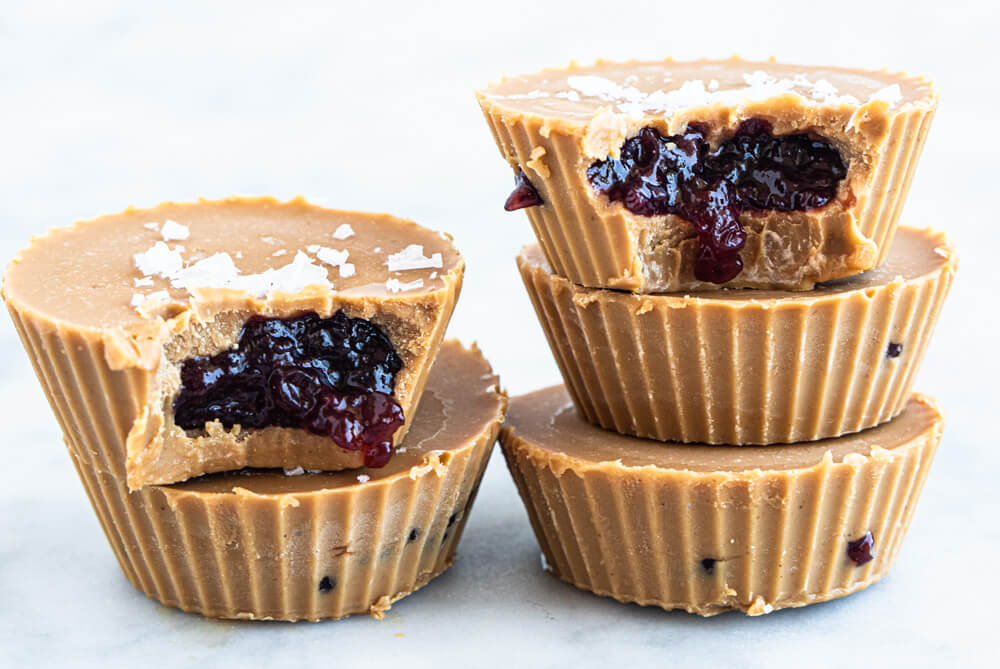 five peanut butter and jelly cups on white counter