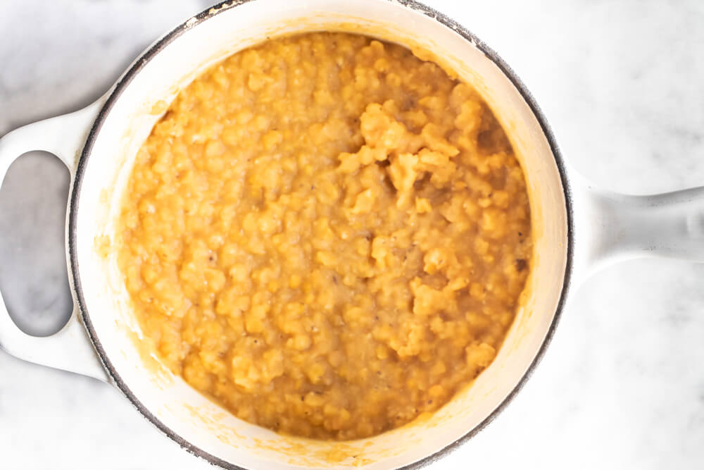 cooked red lentils in a white pot