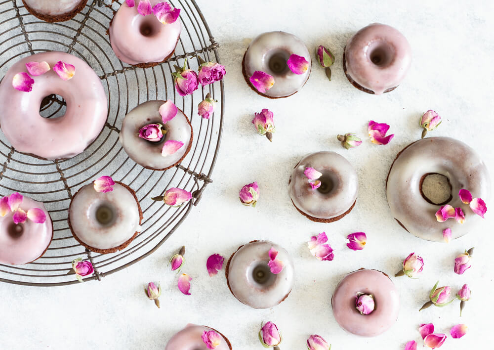 Chocolate Rose Donuts on white table and on wire rack