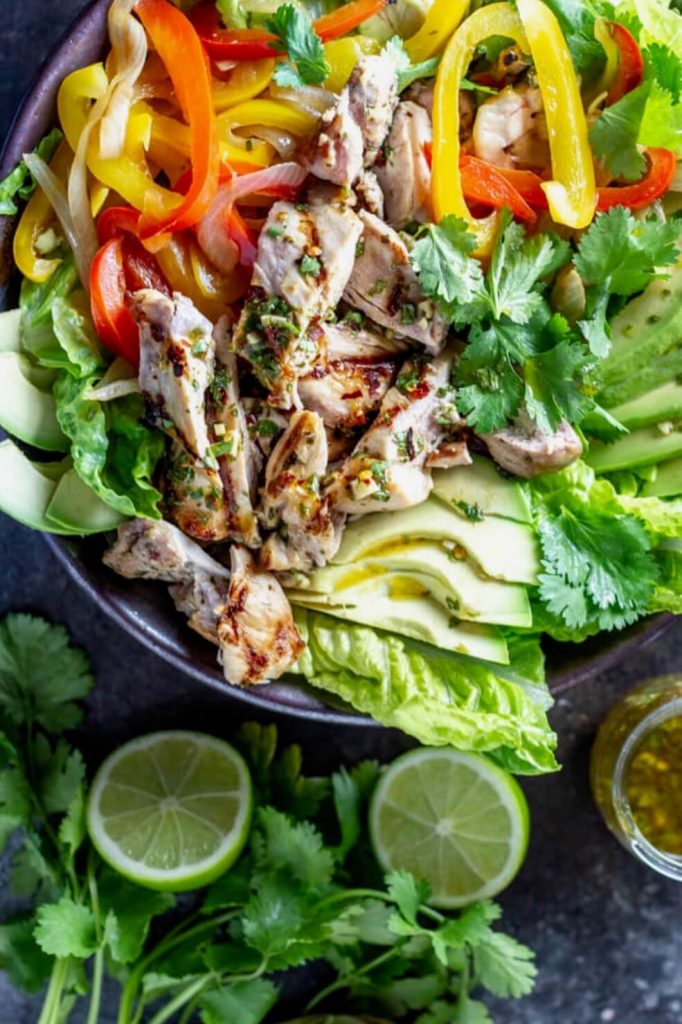 close up of chicken fajita salad with avocado slices