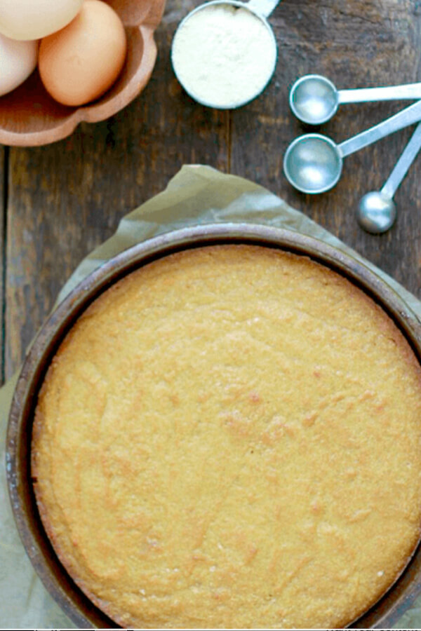 yellow cake in dark cake pan
