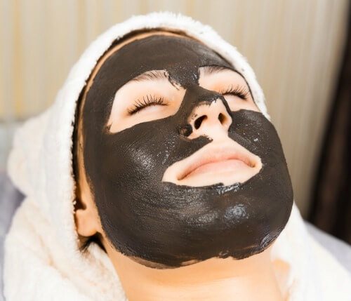 woman with dark mask on her face