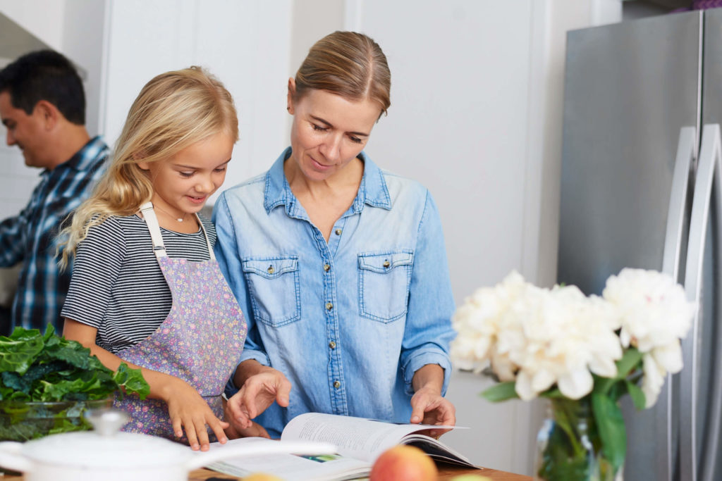 family looking at cookbook