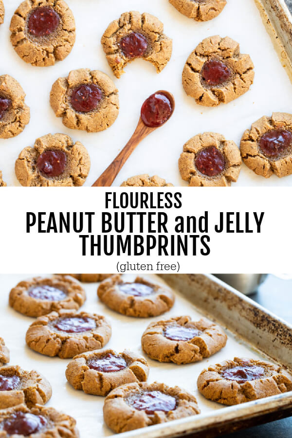 peanut butter and jelly thumbprint cookies on silver tray on parchment paper
