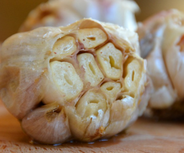 roasted garlic bulb on cutting board